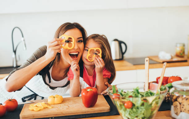 istock Mother and daughter having fun in the kitchen 645632920