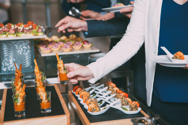 istock Cropped Woman Taking Snack from Buffet Table 645635840