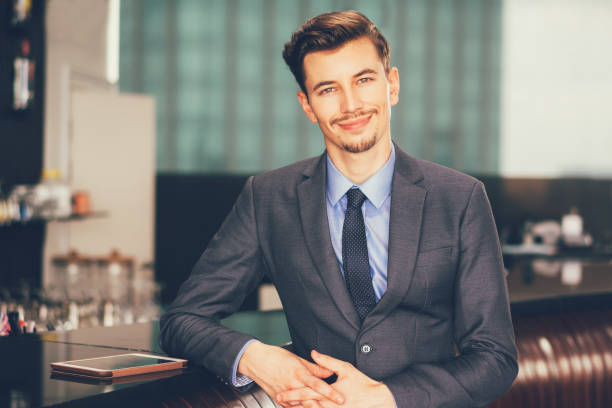 istock Smiling Handsome Businessman at Cafe Counter 645635952