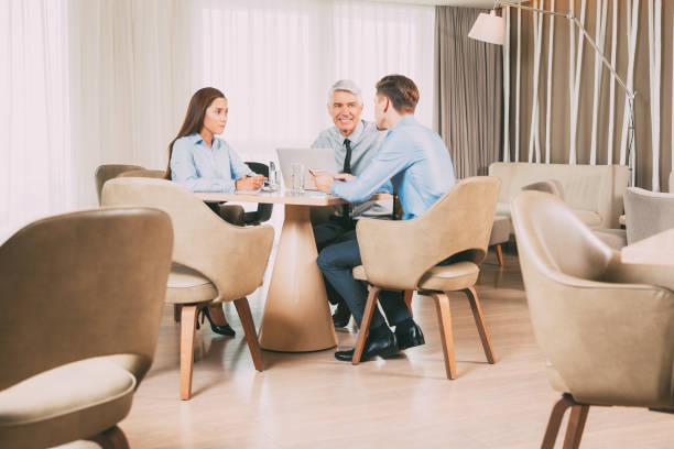 istock Three Business Colleagues Discussing Ideas in Cafe 645635982