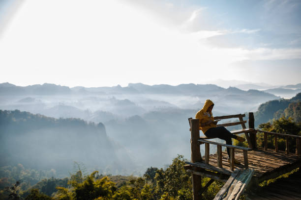 istock Man sitting on veranda and playing on tablet . 645641834