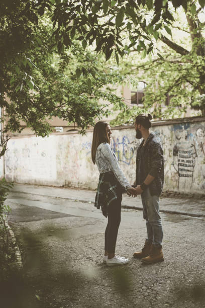 Couple holding hands outdoors.