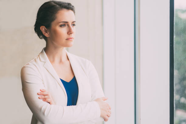 istock Thoughtful Businesswoman Looking Through Window 645646140