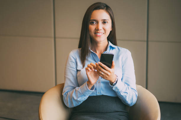 istock Smiling Middle-aged Businesswoman Using Smartphone 645646142