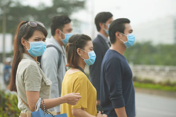 Flue outbreak People wearing face masks beacuse of flue outbreak h1n1 flu virus stock pictures, royalty-free photos & images