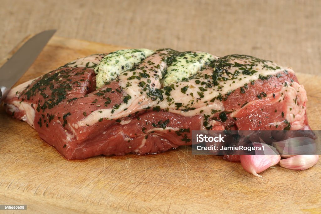 lamb joint with garlic and herbs uncooked lamb shoulder with garlic and herb butter Lamb - Animal Stock Photo