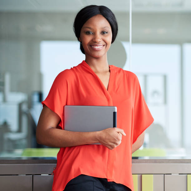 istock Black entrepreneur smiling at camera while standing in business lounge 645664462