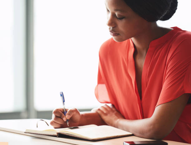istock Tight image of elegant young black writer busy hand writing 645667064