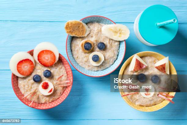 Funny Bowls With Oat Porridge With Cat Dog And Mouse Faces Made Of Fruits And Berries Food For Kids Idea Top View Stock Photo - Download Image Now