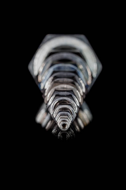 several iron bolts small nut in foreground with large nuts on backgroundsmall nut in foreground with large nuts on background machinerie stock pictures, royalty-free photos & images