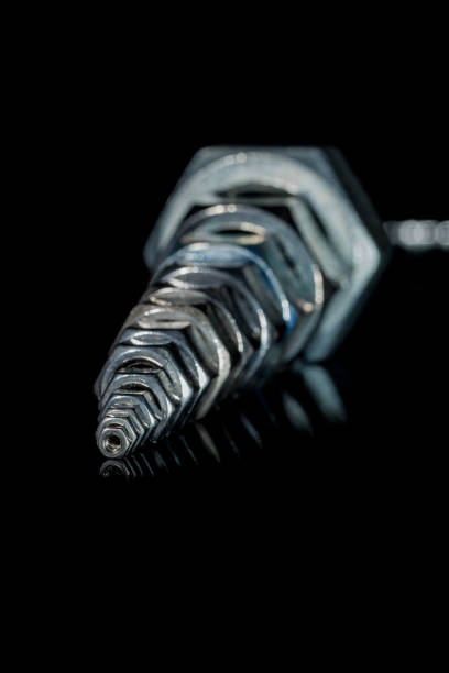 several iron bolts small nut in foreground with large nuts on backgroundsmall nut in foreground with large nuts on background machinerie stock pictures, royalty-free photos & images