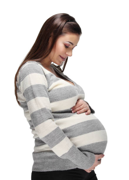 Happy pregnant woman touching her belly