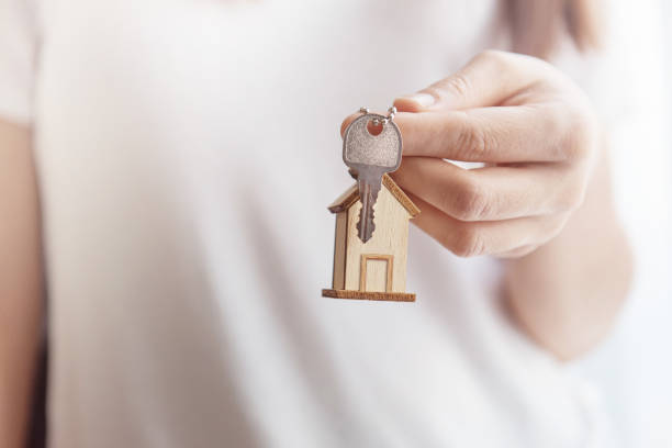 istock Female hand holding house key 645678172
