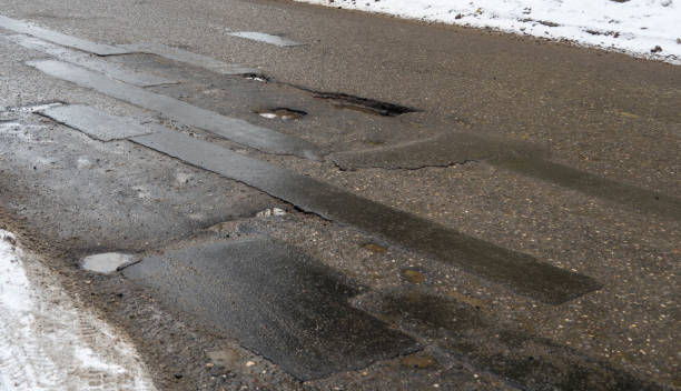 istock Hole in the asphalt, bad road 645694238
