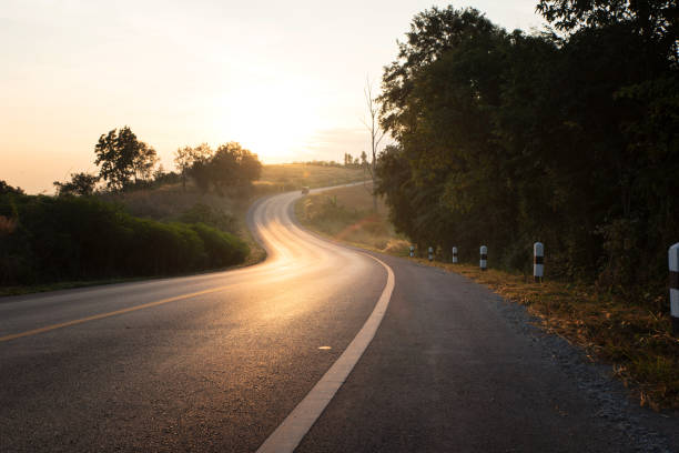 istock Hill and country road in morning 645701172