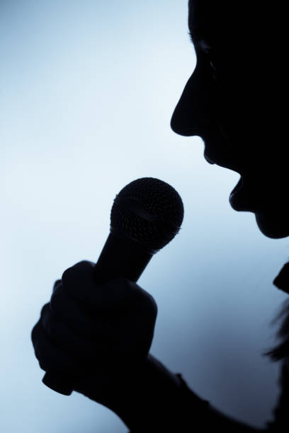 istock Woman singing to microphone 645702052