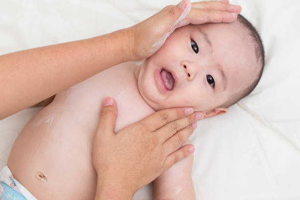 istock Mother applying baby powder for son 645702170