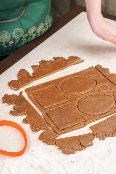 istock Removing the remnants of dough remaining after cutting shaped gingerbread 645709250