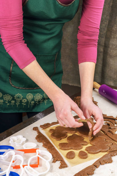 istock Removing the remnants of dough remaining after cutting shaped gingerbread 645709324