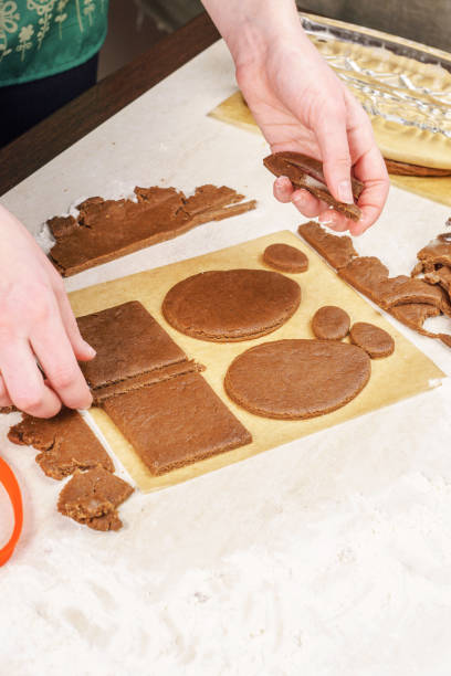 istock Removing the remnants of dough remaining after cutting shaped gingerbread 645711902