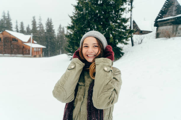 istock Happy woman standing outdoors in winter 645712784