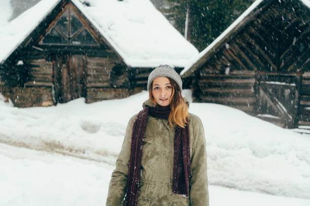 istock Happy woman standing outdoors in winter 645712786