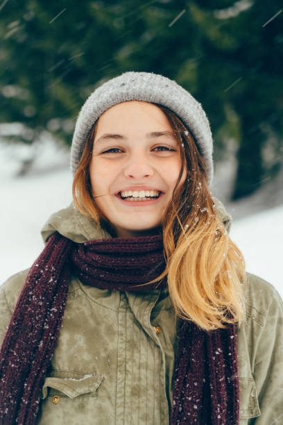 istock Happy woman standing outdoors in winter 645712788