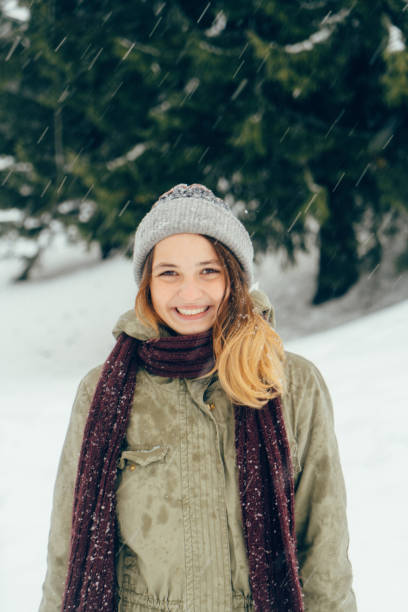 istock Happy woman standing outdoors in winter 645712792