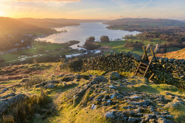 istock Vibrant Lake District Sunrise With Wall And Stile. 645718878