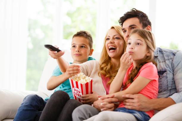 istock Family watching TV on living room sofa 645720080