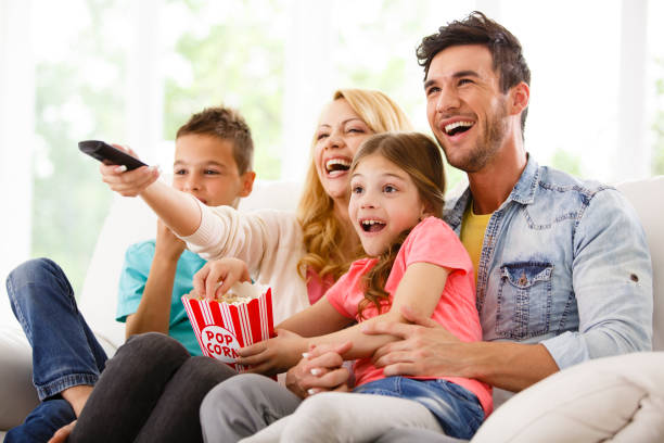 istock Family watching TV and eating popcorn 645720506