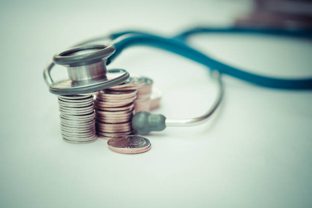Stethoscope on stack of coins, concept of Financial Health stock photo