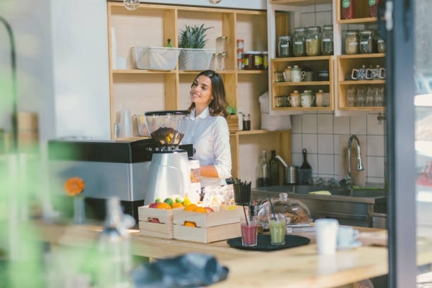 istock Smiling Woman Working In Her Cafe 645728840