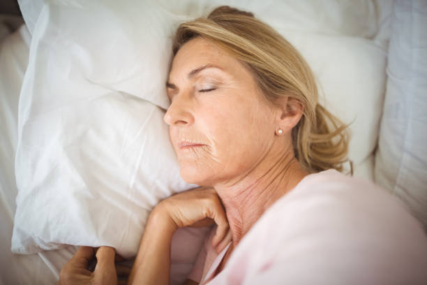 istock Senior woman sleeping on bed 645729154