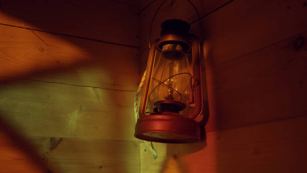 istock Ancient lamp on a wooden wall. 645741054
