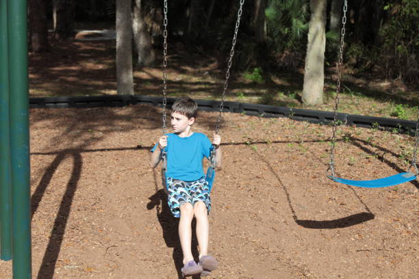 istock Boy with chickenpox is resting at  park`s playground. 645741684