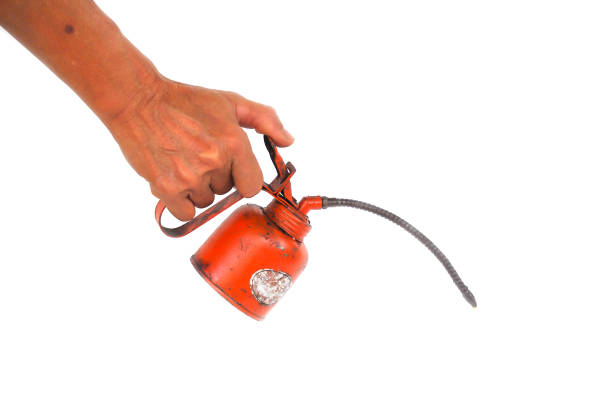 istock Hand holding dirty old Oiler oil on white background. 645742346