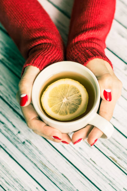 istock Woman holding a cup with tea 645744926