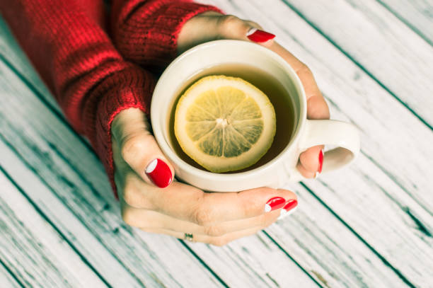 istock Woman holding a cup with tea 645744930