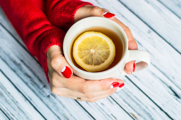 istock Woman holding a cup with tea 645745078