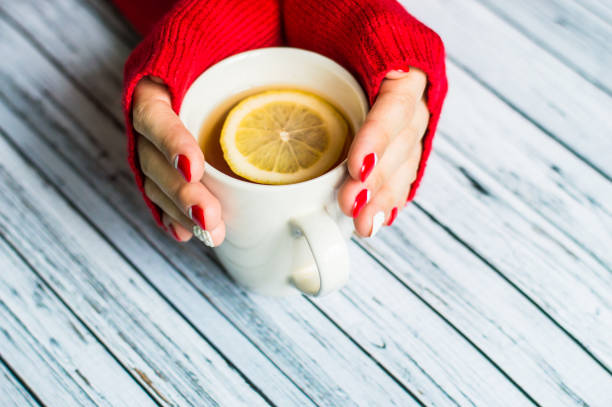 istock Woman holding a cup with tea 645745096