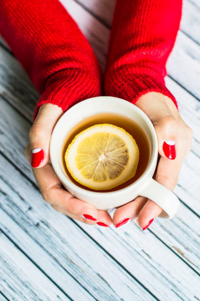 istock Woman holding a cup with tea 645745108