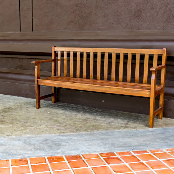 istock Wood bench on concrete floor 645745480