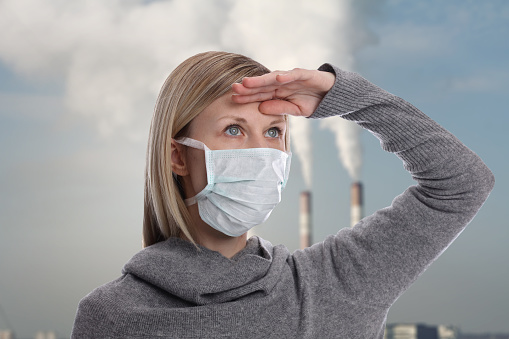 Portrait of woman wearing facial hygienic mask outdoors. Ecology, air pollution, Environmental awareness concept