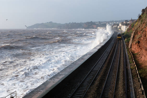 istock Local train at Dawlish in stormy conditions 645752496