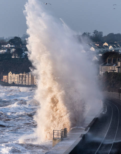 istock Large wave striking sea wall at Dawlish at sunrise 645755362