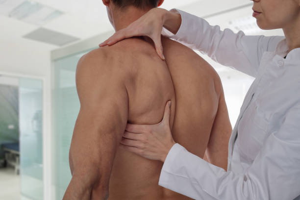 istock Chiropractic, osteopathy, manual therapy, acupressure. Therapist doing healing treatment on man's back. Alternative medicine, pain relief concept. Rehabilitation after Back Injury, Physical therapy. 645757866