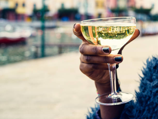 istock Female hand holding  calyx with white wine 645761118
