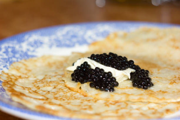 istock Black caviar on Russian pancakes. Selective focus. 645761498