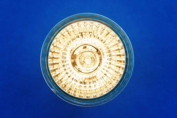 Photo of Halogen bulb close up on blue background